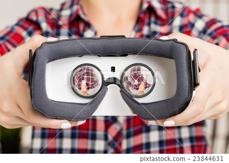 Girl getting experience using VR glasses of Girl getting experience using VR glasses of 23844631