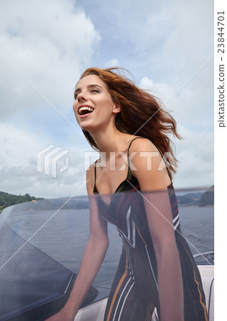 Summer vacation - young woman driving a motor boat 23844701