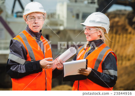 Two people working Two people working 23844916