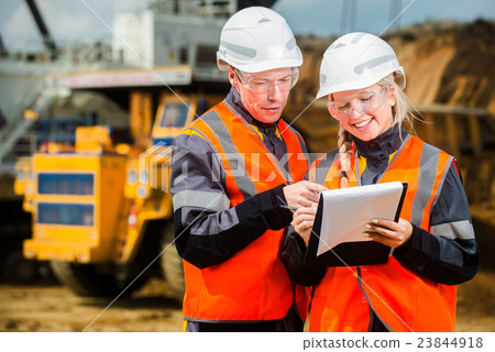 Two people working Two people working 23844918