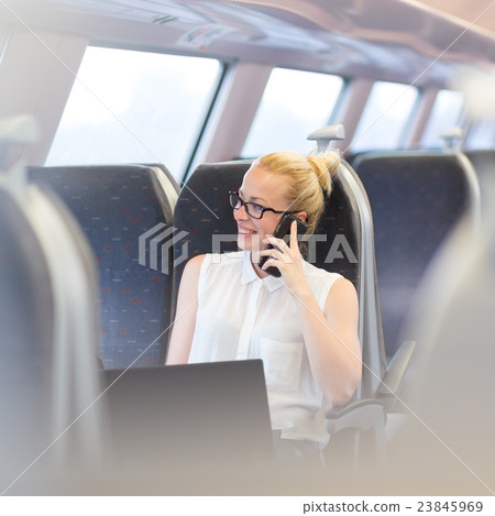 Business woman working while travelling by train. Business woman working while travelling by train. 23845969