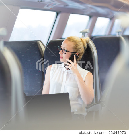 Business woman working while travelling by train. 23845970