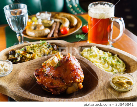 eisbein with braised cabbage, salad and beer 23846841