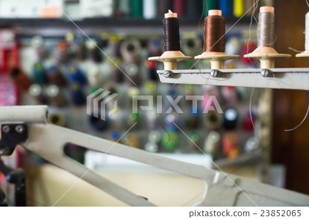 Spools of threads in stitching section Spools of threads in stitching section 23852065