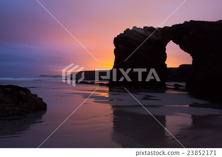 Natural arch at As Catedrais beach in sunrise Natural arch at As Catedrais beach in sunrise 23852171