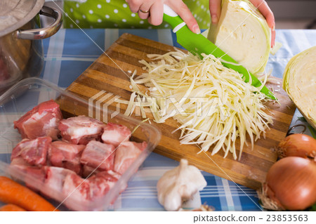 Woman chopping cabbage for soup Woman chopping cabbage for soup 23853563