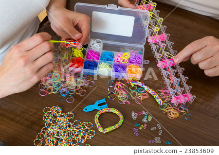 Closeup of women making decorative bracelets Closeup of women making decorative bracelets 23853609