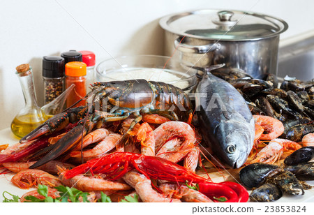 Fresh raw seafoods and fish at table Fresh raw seafoods and fish at table 23853824