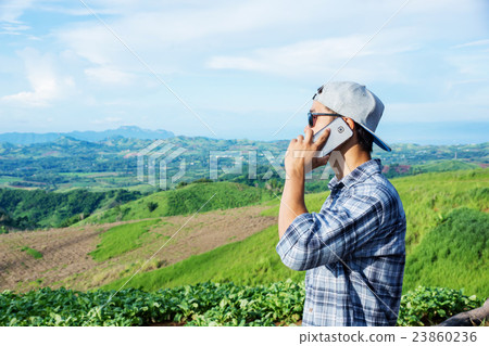 Man using a smartphone at the mountain. 23860236