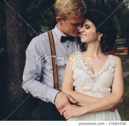 groom gently embracing his bride groom gently embracing his bride 23864206