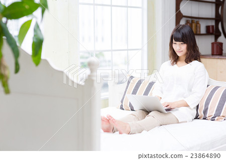 A woman relaxing in bed A woman relaxing in bed 23864890