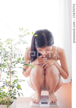 Women riding a scale, diet, beauty, look into Women riding a scale, diet, beauty, look into 23870741