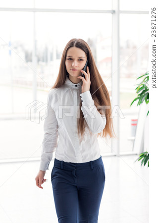 Business woman talking on the mobile phone 23871276