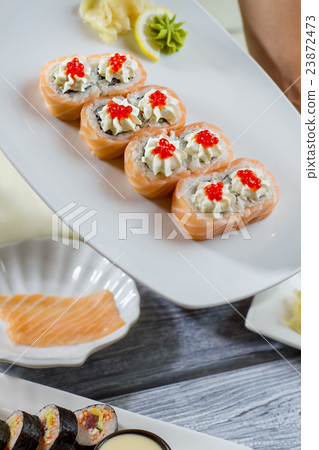 Sushi and wasabi with lemon. 23872473