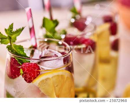 On wooden boards glasses with raspberry mohito and 23872968