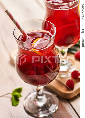 On wooden is ice cold beverage glass with berries 23872969