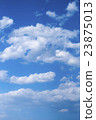 A blue sky with clouds overlapping 23875013