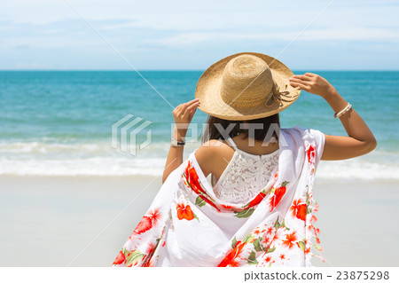 Travel asia woman with hat and dress on sea 23875298