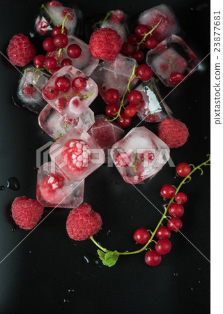Frozen berries on wooden table 23877681