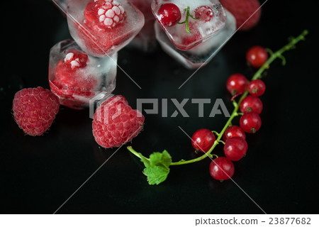 Frozen berries on wooden table 23877682
