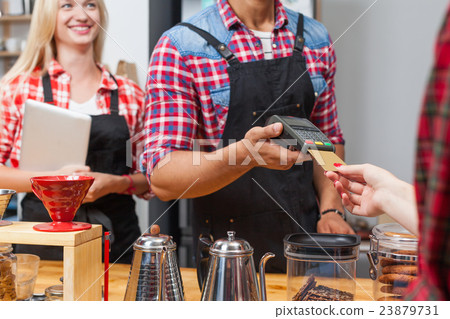 Close up credit card payment coffee shop bar Close up credit card payment coffee shop bar 23879731
