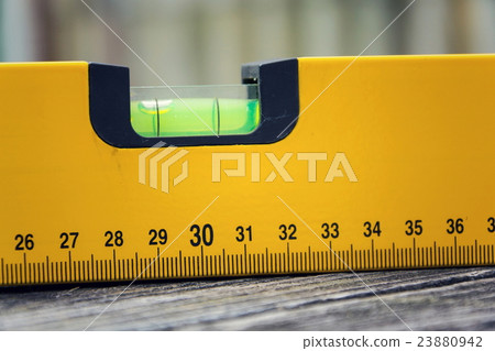 Bubble spirit water level tool on wooden board Bubble spirit water level tool on wooden board 23880942