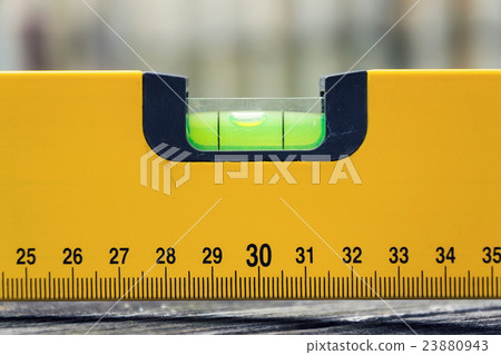 Bubble spirit water level tool on wooden board Bubble spirit water level tool on wooden board 23880943