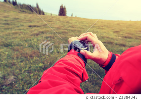 checking the altimeter on sports watch   23884345