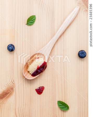 blueberry cheesecake in wooden spoon. 23885396