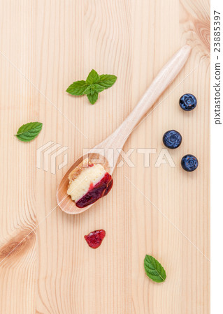 blueberry cheesecake in wooden spoon. 23885397