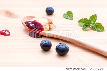 blueberry cheesecake in wooden spoon. 23885398