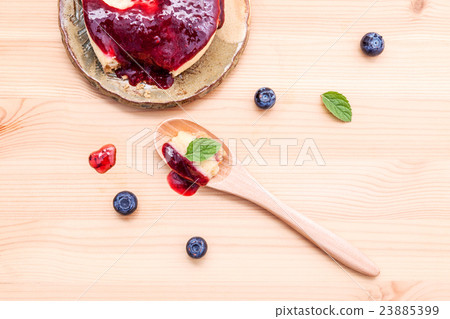 blueberry cheesecake in wooden spoon. 23885399