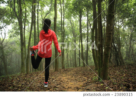 young woman runner stretching legs before run young woman runner stretching legs before run 23890315