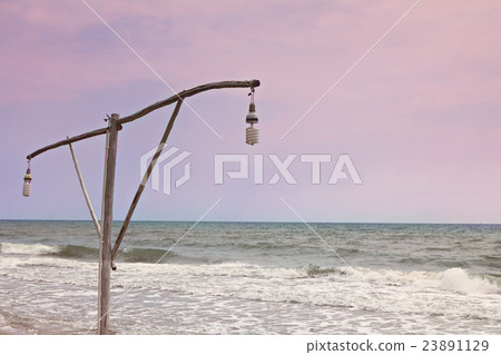 Lamp pole with the sea on evening time Lamp pole with the sea on evening time 23891129