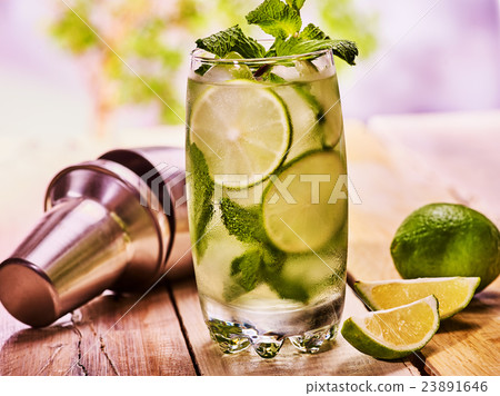 On wooden boards is glasses with mohito. 23891646