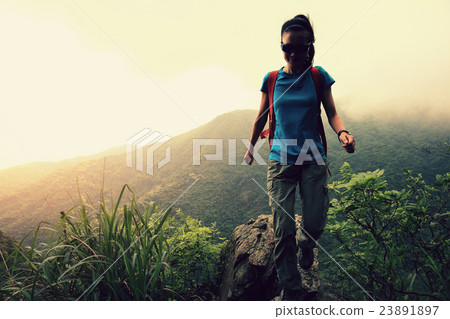 young asian woman hiker hiking at mountain peak young asian woman hiker hiking at mountain peak 23891897