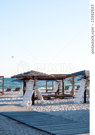 Sun loungers under an umbrella 23892683