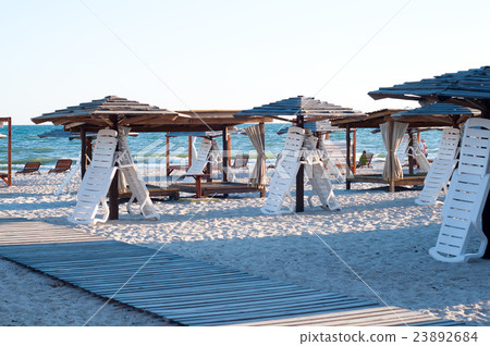 Sun loungers under an umbrella Sun loungers under an umbrella 23892684