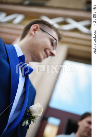 Portrait of young groom in blue tuxedo 23893465