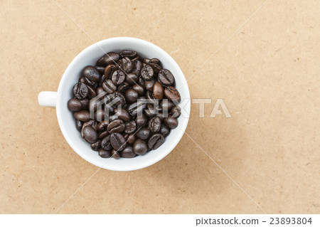 Coffee cup and coffee bean on a wooden table 23893804