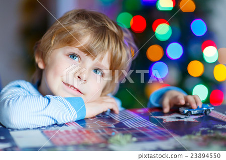 Little blond child playing with cars and toys at Little blond child playing with cars and toys at 23894550
