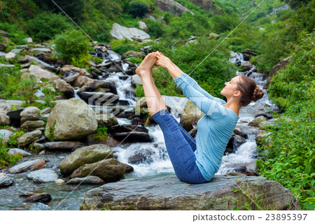 Woman doing Ashtanga Vinyasa Yoga asana outdoors 23895397