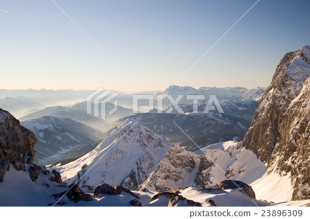 Alpine landscape of snow covered mountains and sky Alpine landscape of snow covered mountains and sky 23896309