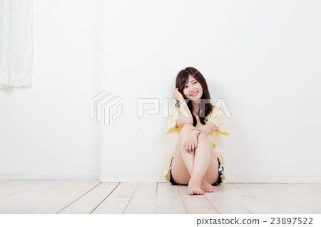 A woman sitting in gym A woman sitting in gym 23897522