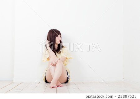 A woman sitting in gym A woman sitting in gym 23897525