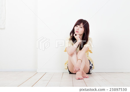 A woman sitting in gym A woman sitting in gym 23897530