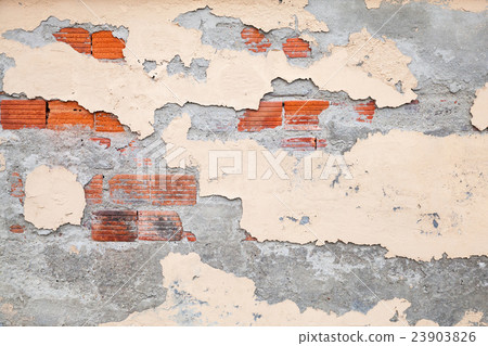 Old brick wall with damaged stucco and paint 23903826