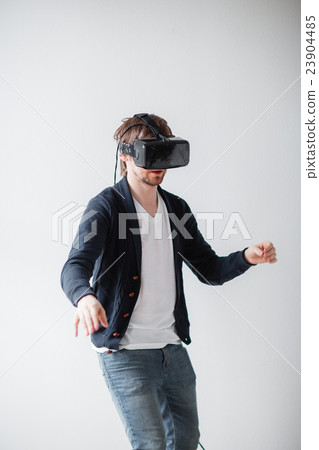 Handsome man wearing virtual reality glasses 23904485