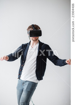 Handsome man wearing virtual reality glasses 23904486