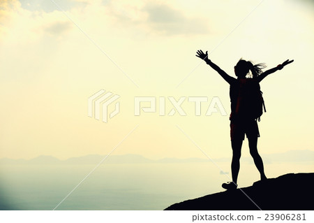 woman hiker enjoy the view on mountain top rock 23906281